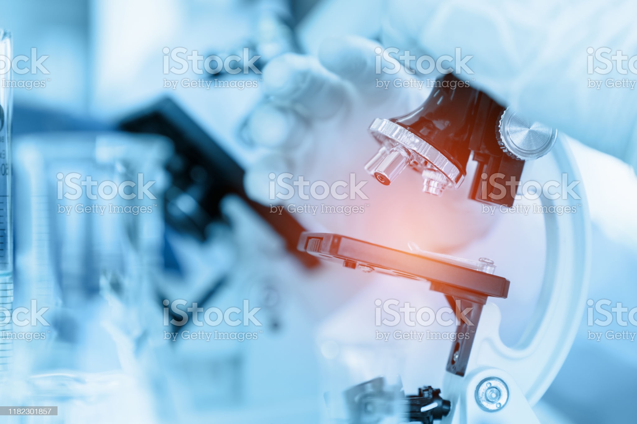 Close Up Scientist using microscope in laboratory room while making medical testing and research